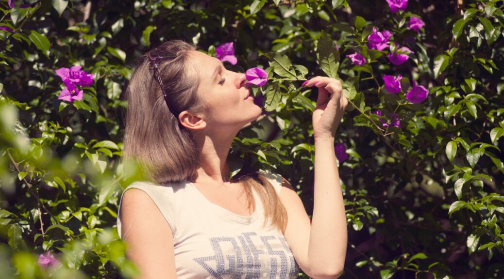 how to cure anosmia-woman smelling flowers